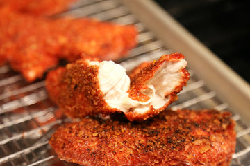 Chicken tenders coated with red takis chips