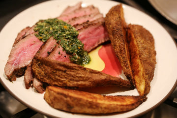 White plate with Flank Steak and Aji Charapita Chimichurri